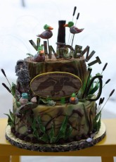 Duck Dynasty birthday cake with lots of camo, cattails, ducks and a duck call